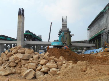 MELAKA, MALAYSIA -MARCH 1, 2022: Excavators machine at the construction site. It is used to excavate and lifting soil and other material at the construction site. 