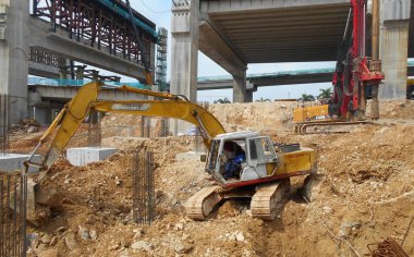 MELAKA, MALAYSIA -MARCH 1, 2022: Excavators machine at the construction site. It is used to excavate and lifting soil and other material at the construction site. 