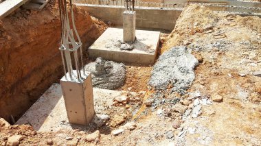 KUALA LUMPUR, MALAYSIA - OCTOBER 5, 2022: Building foundation construction work is being carried out briskly at the construction site. Heavy machinery and construction workers are busy doing work.