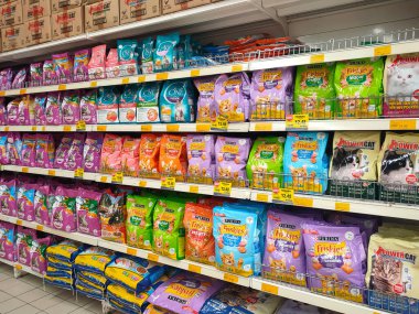 MELAKA, MALAYSIA -JANUARY 9, 2022: Cat food in commercial packs displayed for sale in a supermarket. Placed on the sales rack, and separated by brand and flavor. Has a price tag.