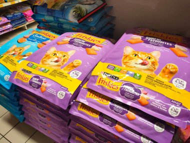 MELAKA, MALAYSIA -JANUARY 9, 2022: Cat food in commercial packs displayed for sale in a supermarket. Placed on the sales rack, and separated by brand and flavor. Has a price tag.