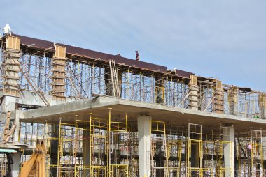 SELANGOR, MALAYSIA -AUGUST 2015: Timber beam formwork supported by row of scaffolding in construction site in Malaysia