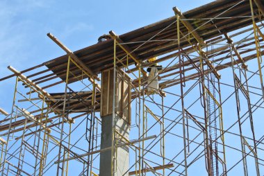 SELANGOR, MALAYSIA -AUGUST 2015: Timber beam formwork supported by row of scaffolding in construction site in Malaysia