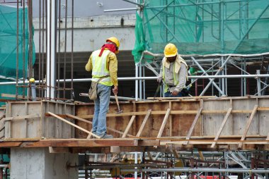 PERAK, MALAYSIA -APRIL 10, 2016: Construction workers fabricating timber form work made from plywood at the construction site in Perak, Malaysia.  