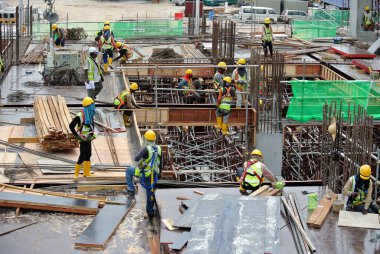 JOHOR, MALAYSIA -APRIL 28, 2016: Group of construction workers working at the construction site at Johor, Malaysia during daytime.  