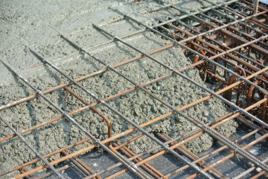 SELANGOR, MALAYSIA -APRIL 16, 2016: The wet concrete is poured on a steel reinforcement to form strong floor slabs.