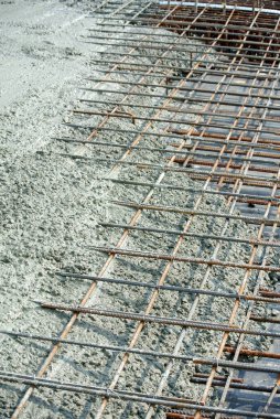 SELANGOR, MALAYSIA -APRIL 16, 2016: The wet concrete is poured on a steel reinforcement to form strong floor slabs.