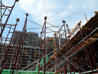 JOHOR, MALAYSIA -APRIL 13, 2016: Scaffolding as the temporary structure used to support platform, form work and structure at the construction site. Also used it as a walking platform for workers. 