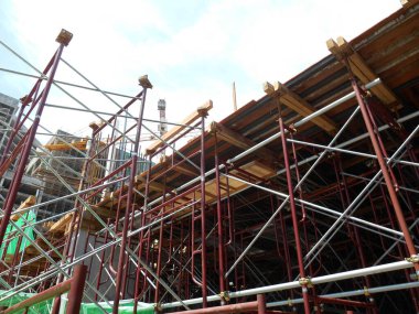 JOHOR, MALAYSIA -APRIL 13, 2016: Scaffolding as the temporary structure used to support platform, form work and structure at the construction site. Also used it as a walking platform for workers. 