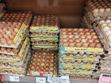 SEREMBAN, MALAYSIA -MARCH 8, 2022: Fresh chicken eggs in a pallet container, for sale in a supermarket. Sort by grade and size.