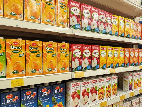 stock image MELAKA, MALAYSIA -MARCH 22, 2022: Juice with fruit flavour packed in a paper box container displayed for sale on the rack inside the supermarkets. Sorted by brands to enable customers to choose.