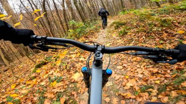 Enduro bicycle ride on the forest trails in the autumn season clipart