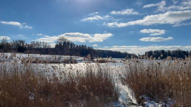 Scenery landscape background with lake and clouds on a sunny day