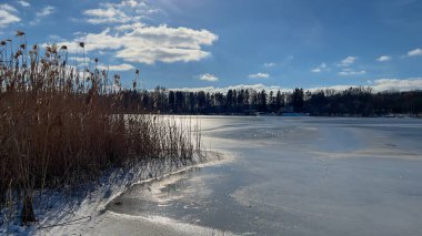 Scenery landscape background with lake and clouds on a sunny day