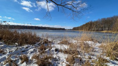 Scenery landscape background with lake and clouds on a sunny day