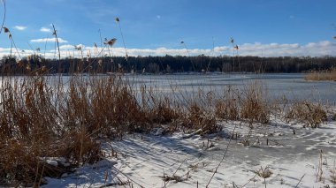 Scenery landscape background with lake and clouds on a sunny day