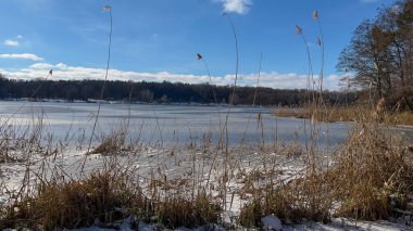 Scenery landscape background with lake and clouds on a sunny day