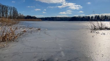 Scenery landscape background with lake and clouds on a sunny day
