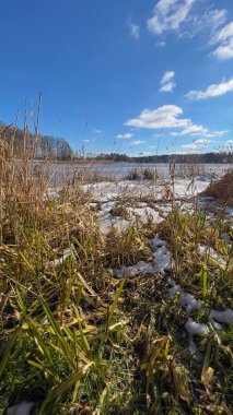 Scenery landscape background with lake and clouds on a sunny day