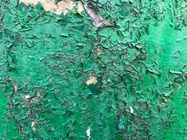 old cracked paint on wall background in grunge style