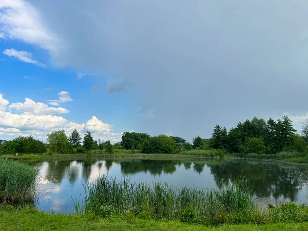 Stock image A beautiful small lake in the countryside. Sunny day with clouds in the sky. Perfect place for relaxing