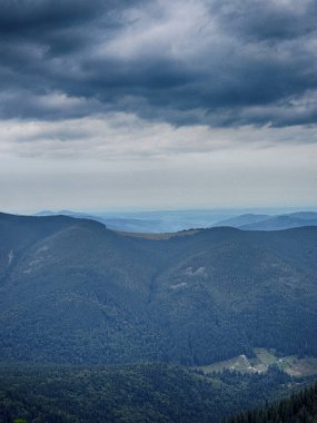 Kasvetli bir Karpatya manzarası, görkemli ve zamansız bulutlu gökyüzü altında.