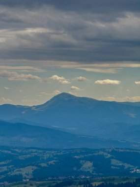 Güneşli Karpat tepeleri: yeşil vadiler ve kristal berrak gökyüzü.