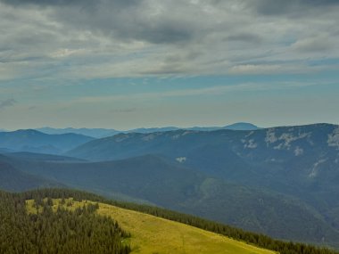 Güneşli Karpat tepeleri: yeşil vadiler ve kristal berrak gökyüzü.