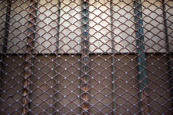 Iron curtain background on a facade