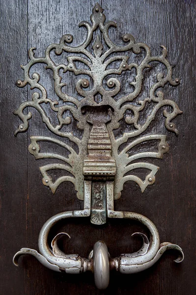Rusty and weathered bronze door knocker