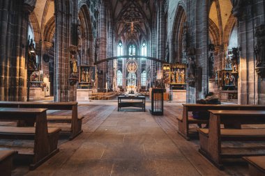 Majestic altar, walls, stained glass windows of the ancient Gothic Catholic Cathedral of Nuremberg, Germany. High quality photo