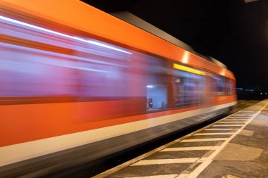 Abstraction - the train moves quickly along the platform. High quality photo