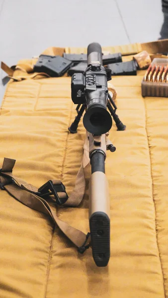 Sniper rifle with optical sight lies on a sniper mat. High quality photo