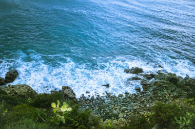 Blue Mediterranean Sea, waves, foam, view from above from a cliff, Cagliari, Sardinia, Italy. High quality photo