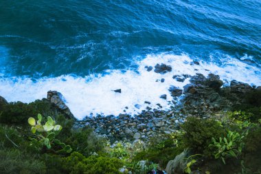 Blue Mediterranean Sea, waves, foam, view from above from a cliff, Cagliari, Sardinia, Italy. High quality photo