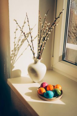 Blooming branches of the pussy willow and colored Easter eggs. Happy Easter and springtime