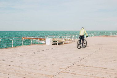 Man driving bicycle on the beach in sunny day. Sport concept