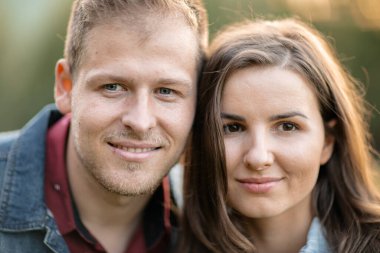 Loving couple smile and bonding together on a field.summer and happy man and happy woman on a travel vacation