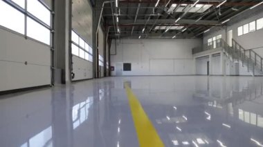 New construction industrial hall with self-leveling gray epoxy resin flooring
