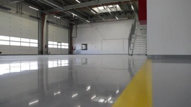 New epoxy floor with colored markings in workshop. Self-leveling coating gray.