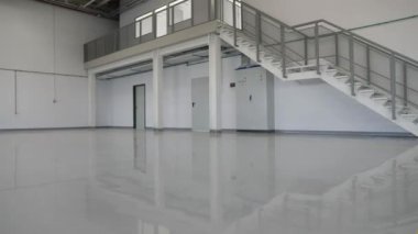 New epoxy floor with colored markings in a car workshop.