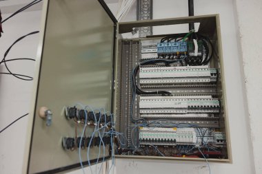 Electrical panel with wires and switches in a modern electrical installation.