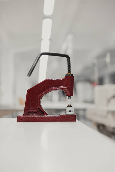 Close-up of a red mold on a white table in a factory