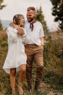 Handsome guy with nice girl hugging on deep intimate moment. Wears casual outfit. outdoors love concept