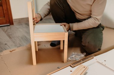 man assembling new furniture bought for home
