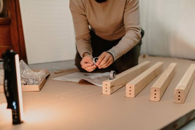 man assembling new furniture bought for home