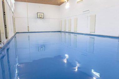 Self leveling blue epoxy floor in the gym clipart