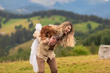 Çiftler koşar, güler, gelin damadın sırtına atlar, derin bir sevgi gösterir, arkasında dağlar olur..