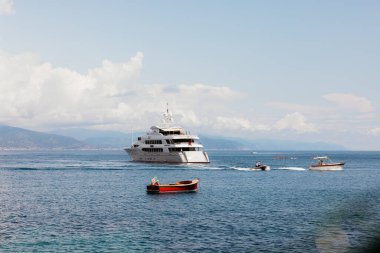Lüks bir yat ligurian denizinde yol alırken, onu daha küçük tekneler takip ediyor.