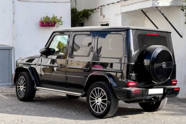 Siyah Mercedes AMG G63 sokağa park edilmiş.